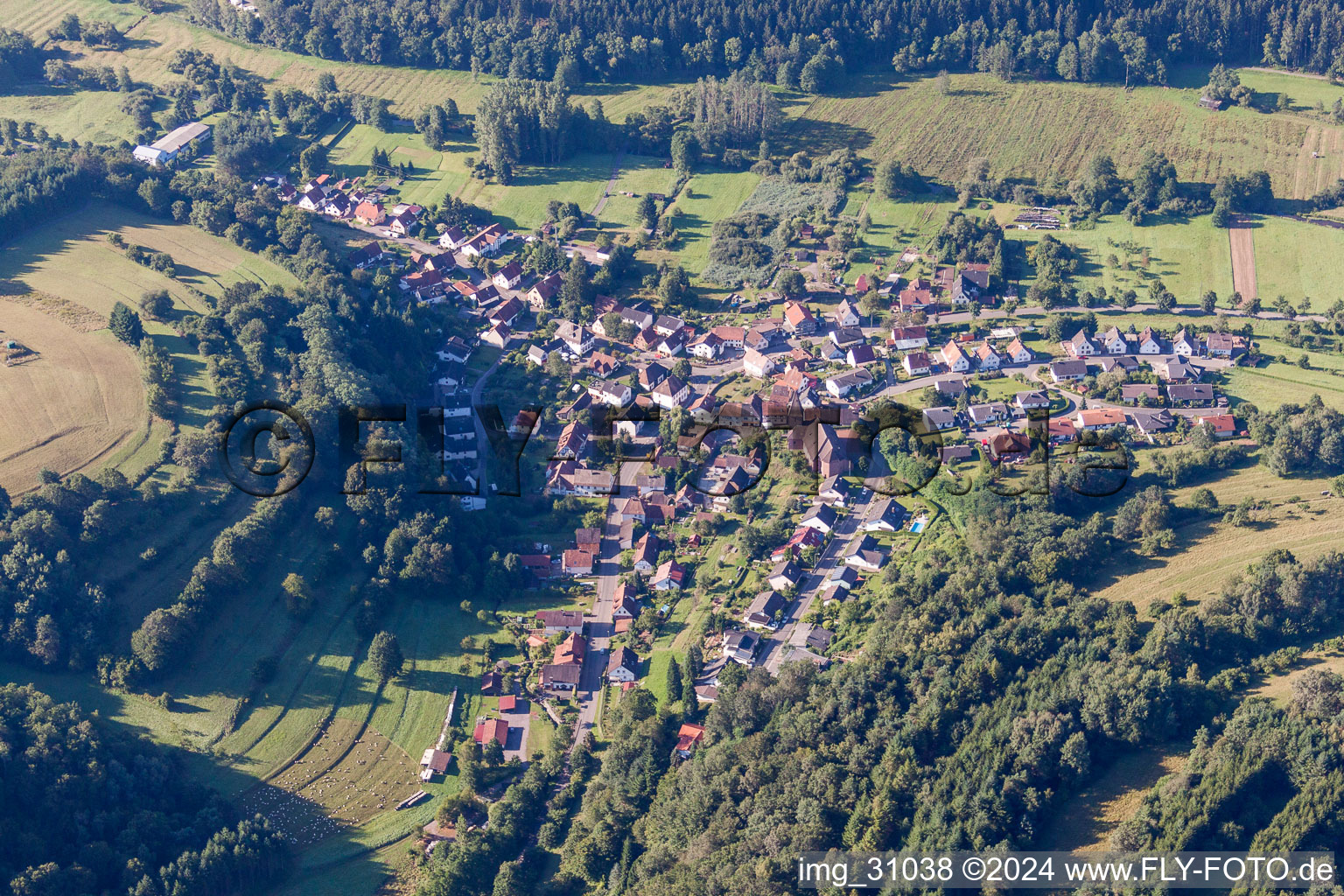 Aerial view of Village - view on the edge of agricultural fields and farmland in Niederschlettenbach in the state Rhineland-Palatinate, Germany