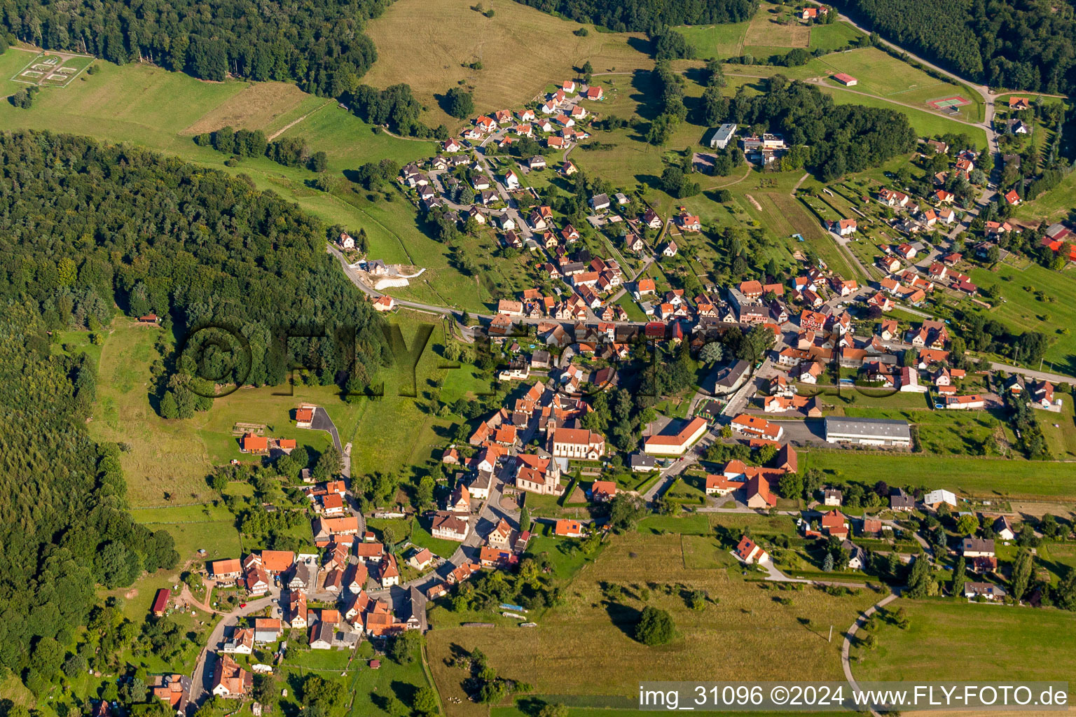 Village - view on the edge of agricultural fields and farmland in Climbach in Grand Est, France