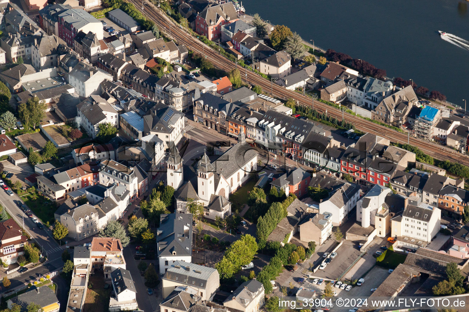 City center with railway in the downtown area on the banks of river course of the Mosel in Wasserbillig in Grevenmacher, Luxembourg