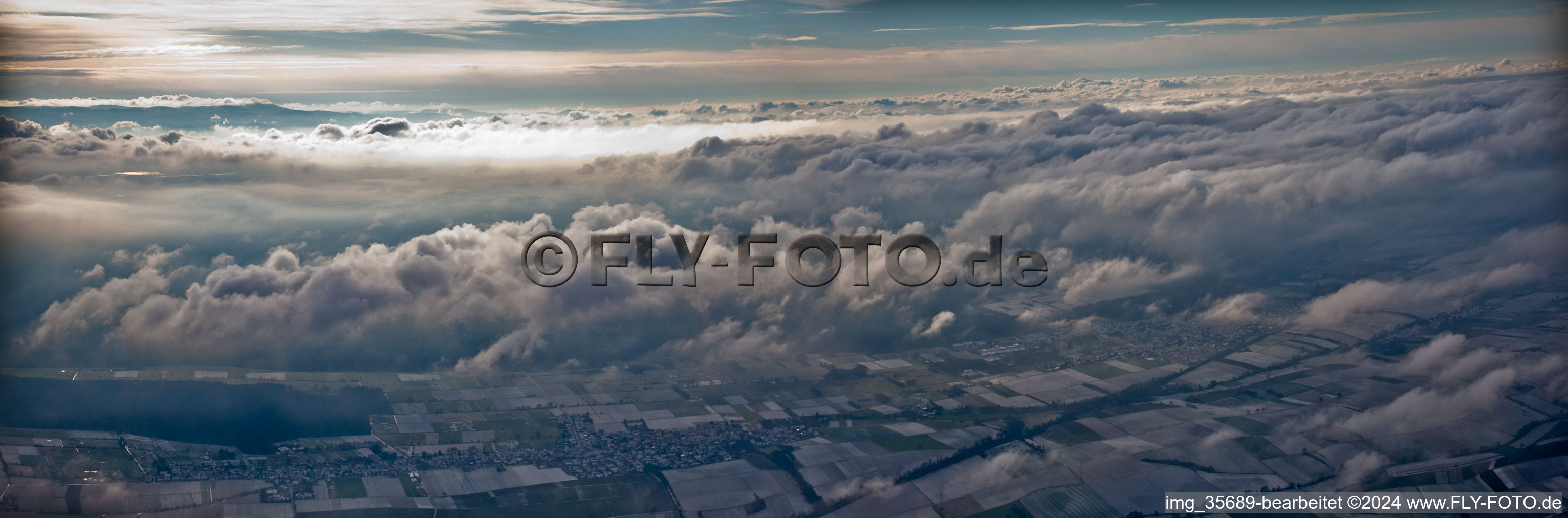 Weather conditions with cloud formation ueber dem winterlichen Bienwald in Freckenfeld in the state Rhineland-Palatinate