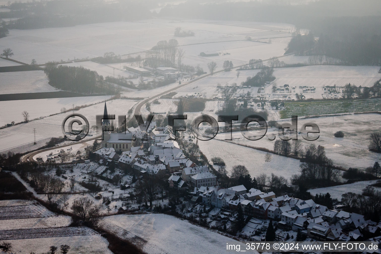 Church building Hinterstaedel church covered with snow in Jockgrim in the state Rhineland-Palatinate in winter