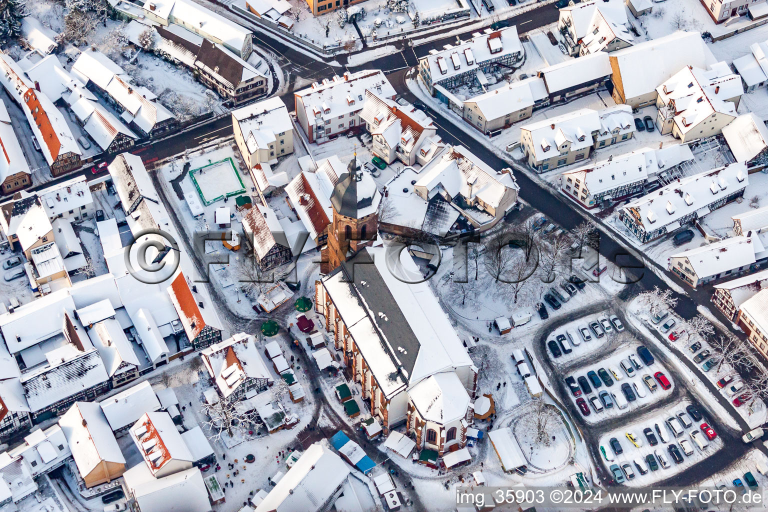 Christmas market at Plätzl and around St. George's Church in snow in Kandel in the state Rhineland-Palatinate, Germany