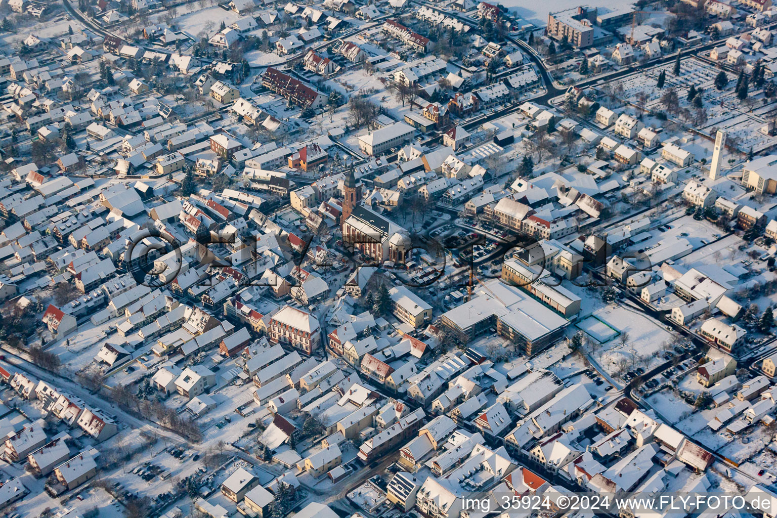 Aerial view of Christmas market at Plätzl and around St. George's Church in snow in Kandel in the state Rhineland-Palatinate, Germany