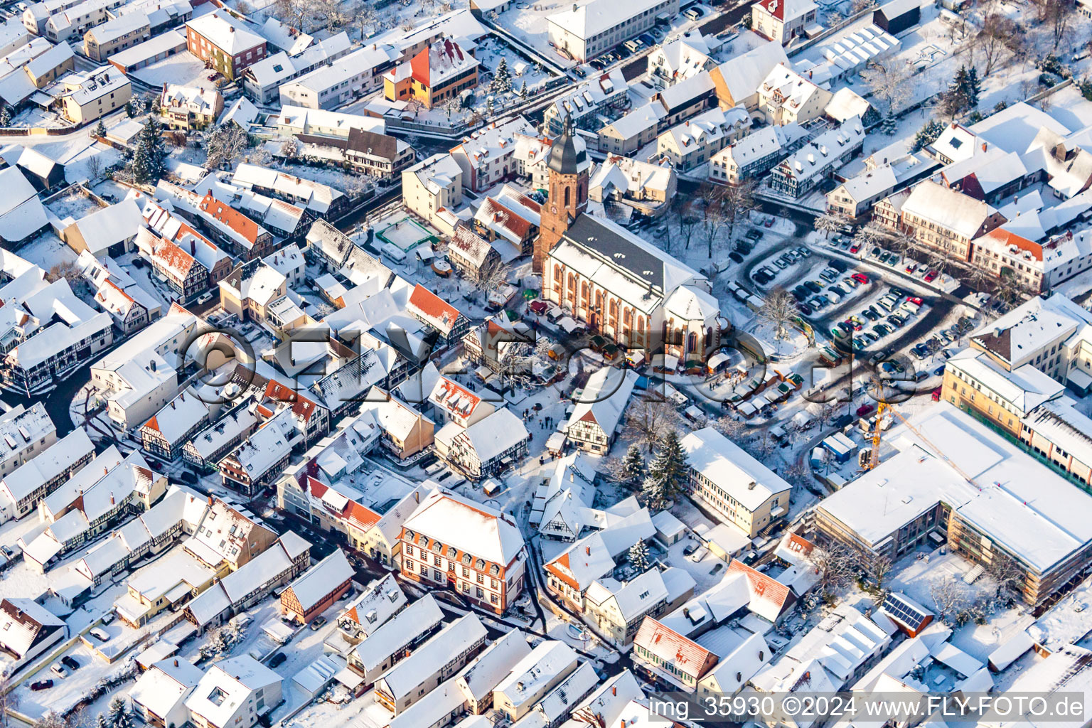 Aerial photograpy of Christmas market at Plätzl and around St. George's Church in snow in Kandel in the state Rhineland-Palatinate, Germany