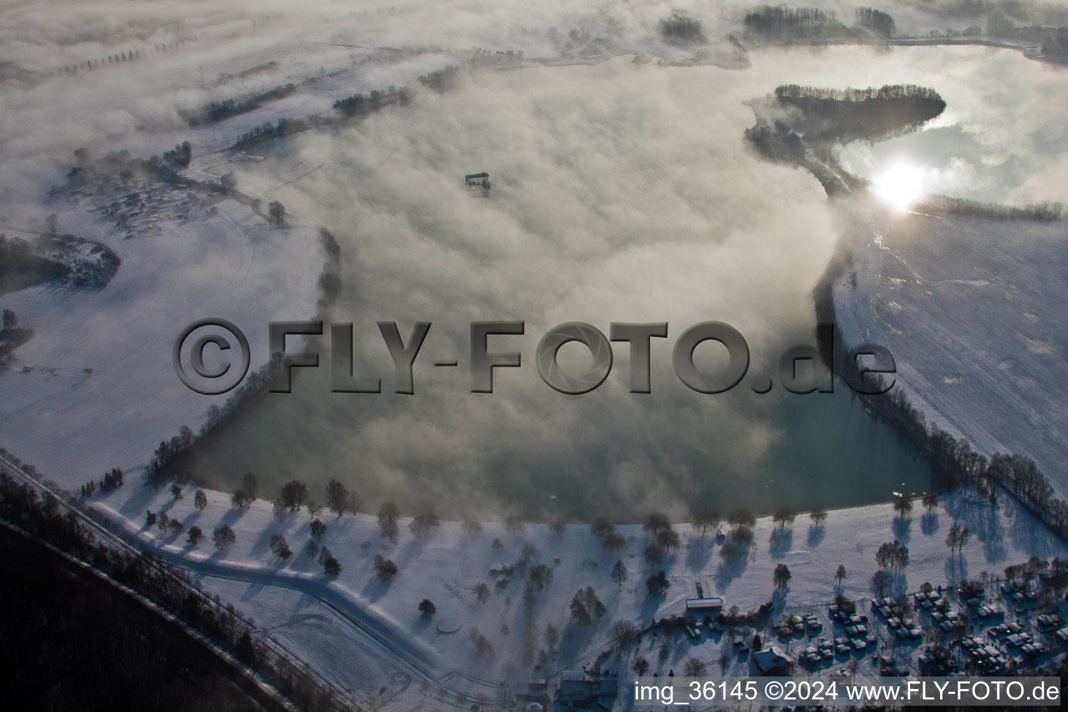 Riparian areas on the lake area of wintry snowy Bassin des Mouettes in Lauterbourg in Grand Est, France