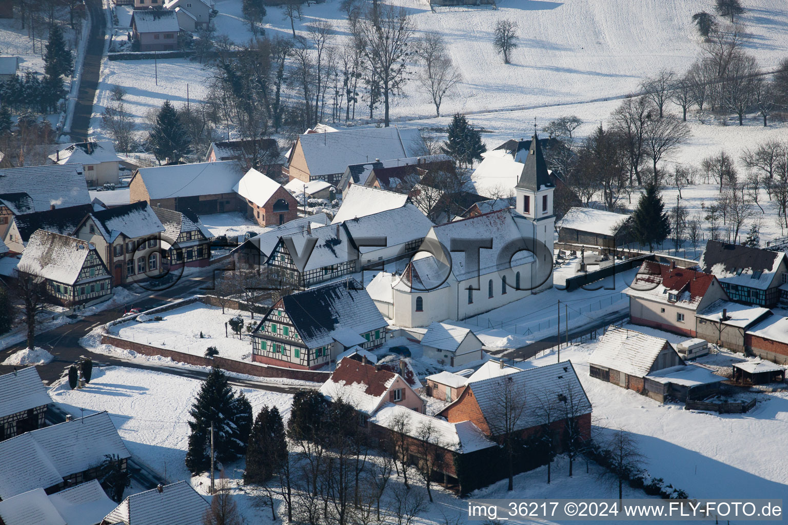 Wintry snowy Church building in the village of in Eberbach-Seltz in Grand Est, France