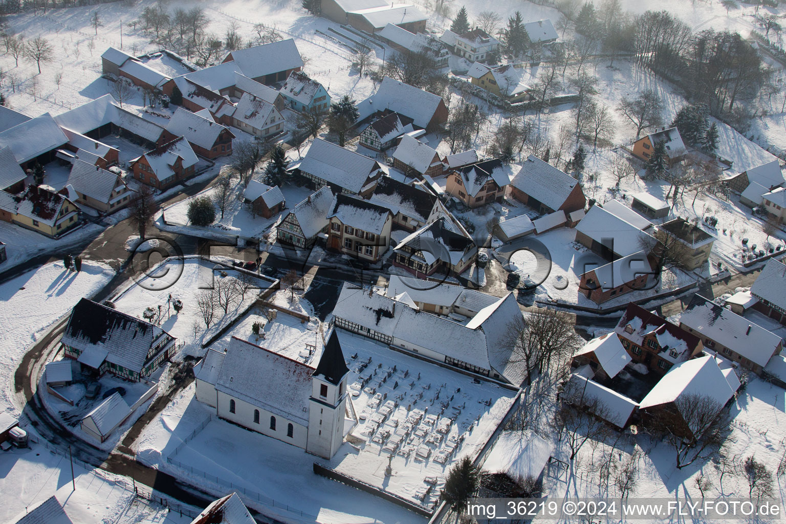 Aerial photograpy of Wintry snowy Church building in the village of in Eberbach-Seltz in Grand Est, France