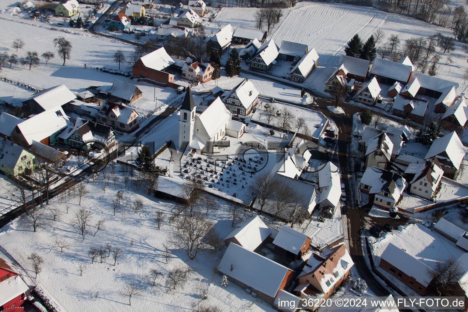 Oblique view of Wintry snowy Church building in the village of in Eberbach-Seltz in Grand Est, France