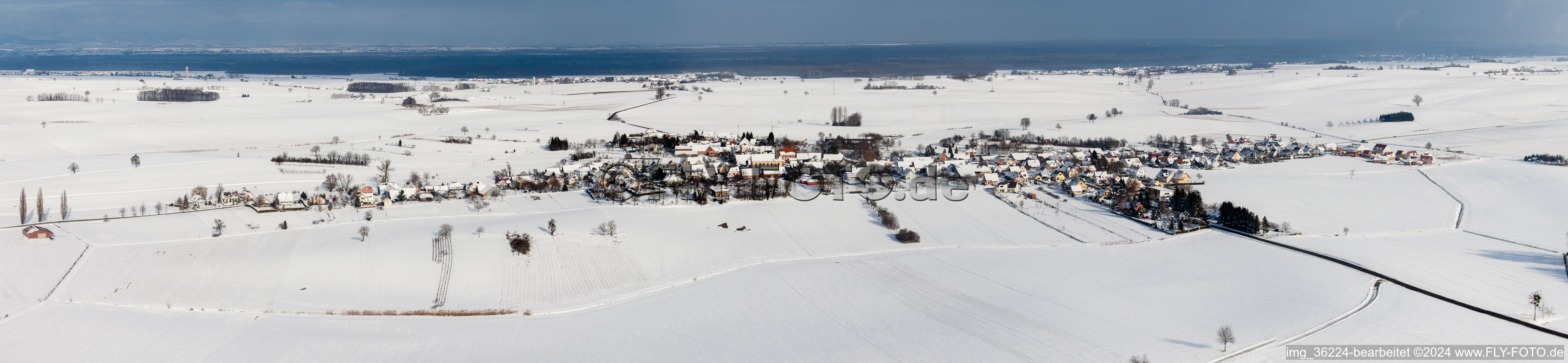 Wintry snowy Panoramic perspective Village - view on the edge of agricultural fields and farmland in Oberlauterbach in Grand Est, France