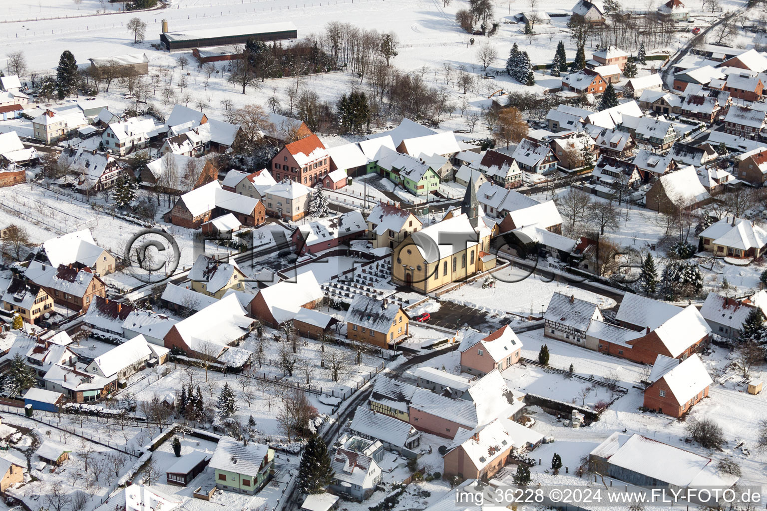 Wintry snowy Church building in the village of in Oberlauterbach in Grand Est, France