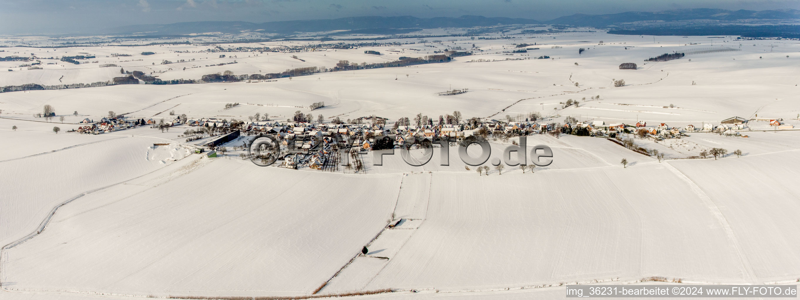 Wintry snowy Panorama perspective of Village - view on the edge of agricultural fields and farmland in Siegen in Grand Est, France