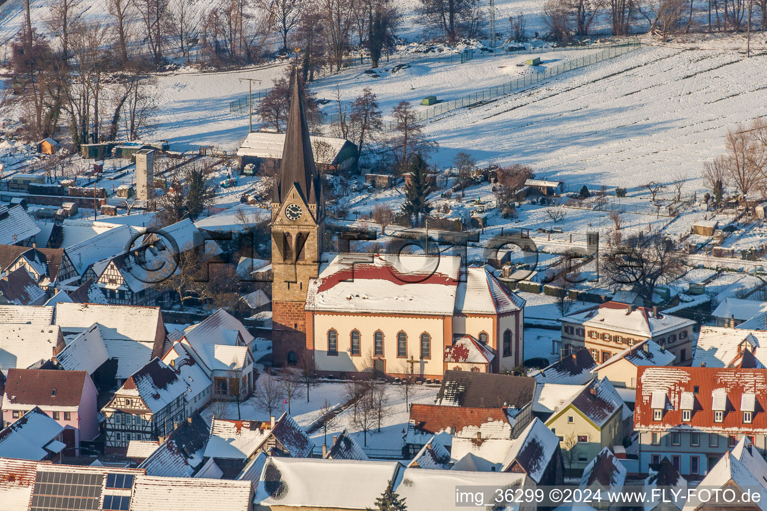 Aerial photograpy of Wintry snowy Catholic Church building in the village of in Steinweiler in the state Rhineland-Palatinate, Germany