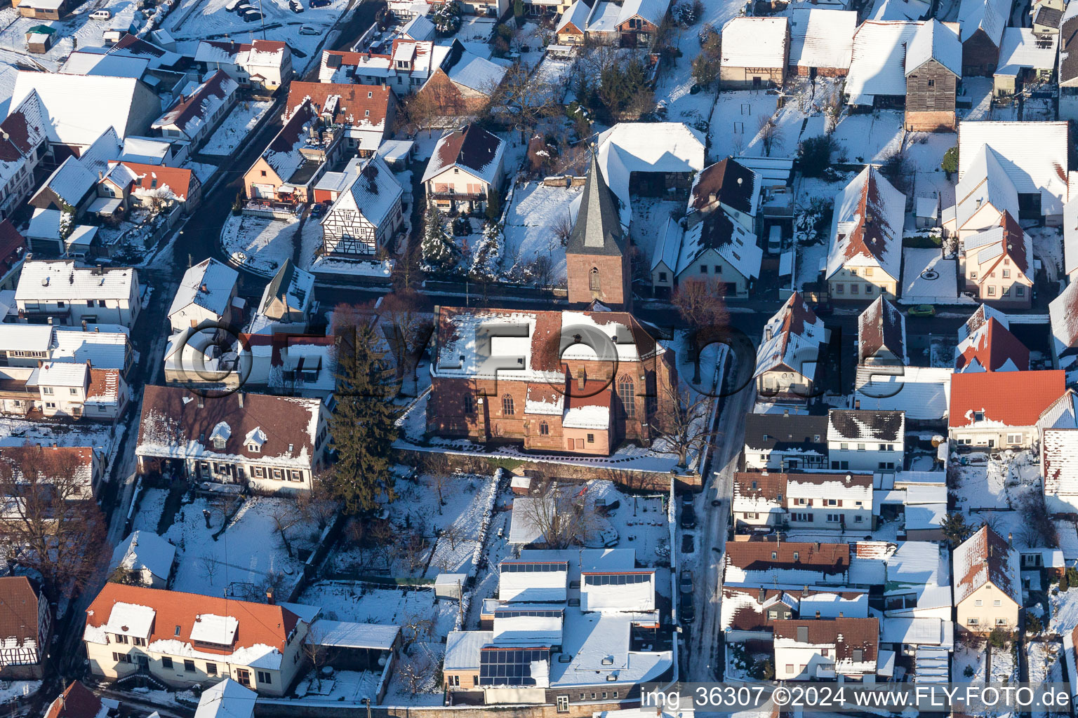 Aerial view of Wintry snowy Church building in the village of in Rohrbach in the state Rhineland-Palatinate, Germany