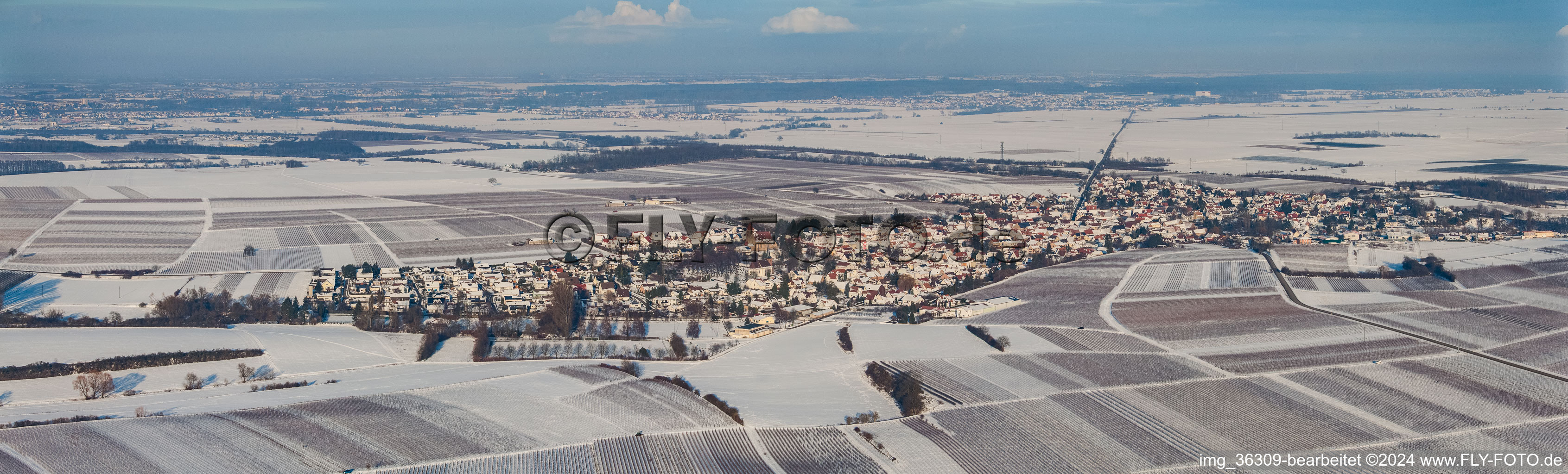 Wintry snowy Panoramic perspective Village - view on the edge of agricultural fields and farmland in Impflingen in the state Rhineland-Palatinate, Germany