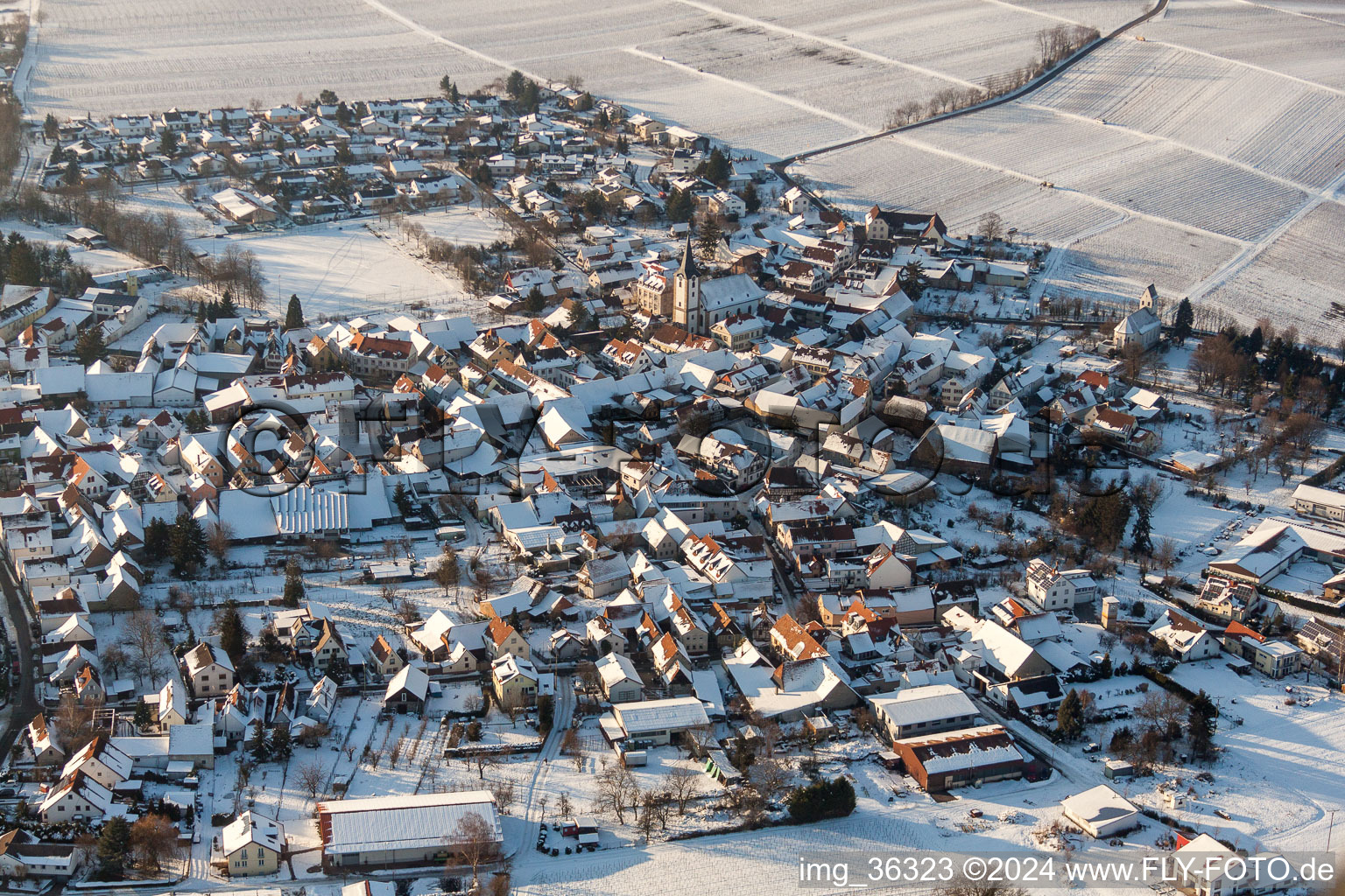 Aerial photograpy of Wintry snowy Village - view on the edge of agricultural fields and farmland in the district Moerzheim in Landau in der Pfalz in the state Rhineland-Palatinate, Germany