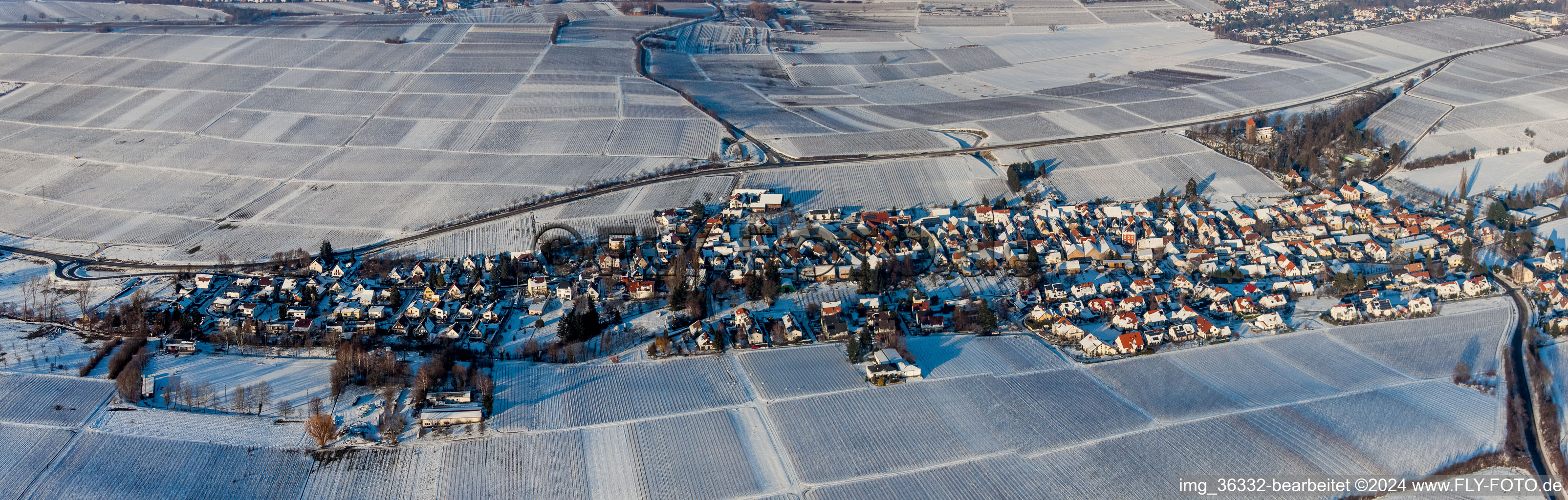 Panorama of winter snow-covered agricultural fields and farmland in the district Wollmesheim in Landau in der Pfalz in the state Rhineland-Palatinate, Germany