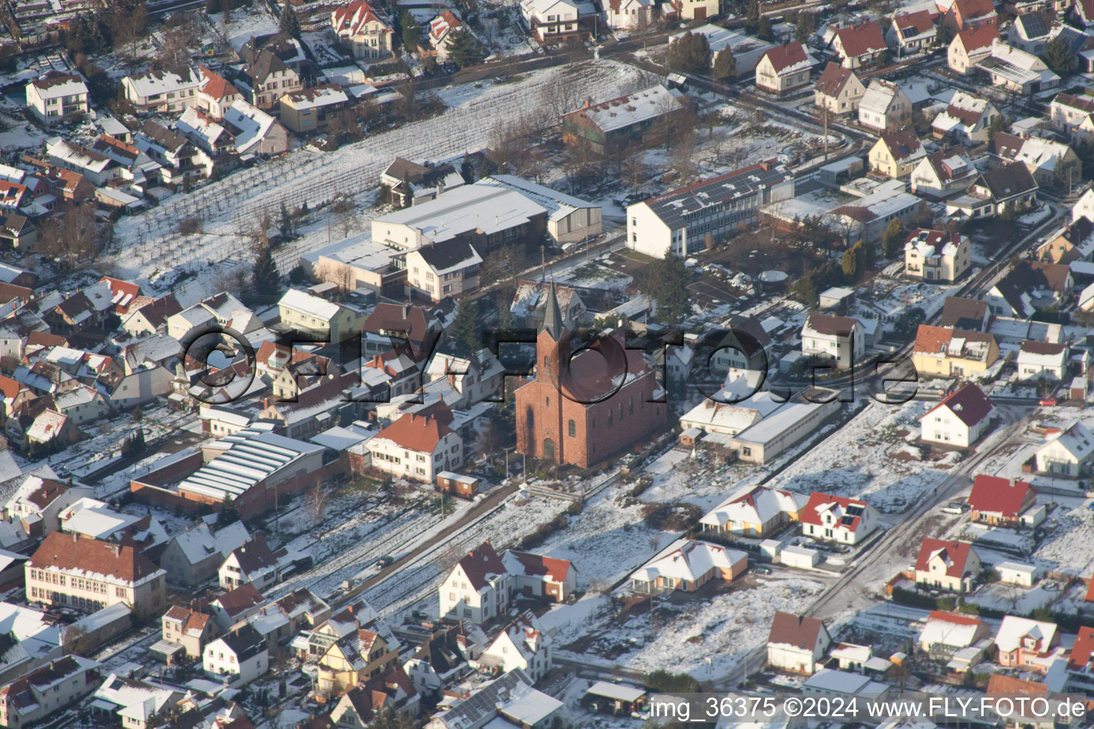 Oblique view of Winterly Town View of the streets and houses of the residential areas in Albersweiler in the state Rhineland-Palatinate