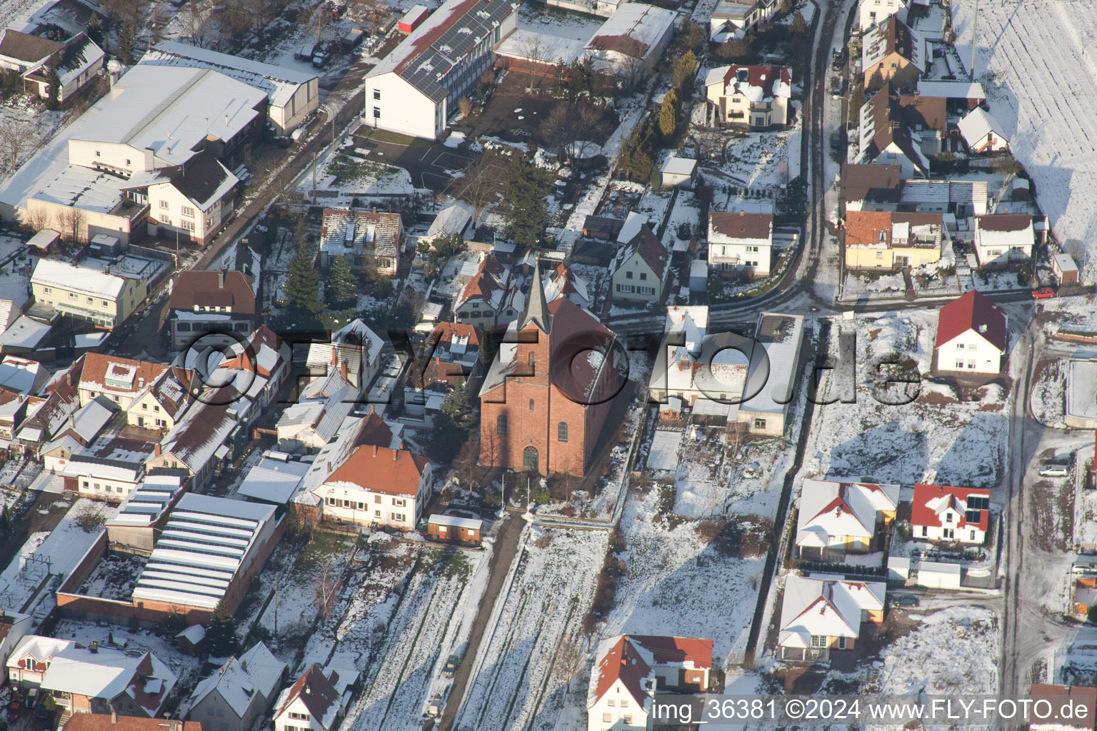 Winterly Town View of the streets and houses of the residential areas in Albersweiler in the state Rhineland-Palatinate seen from above