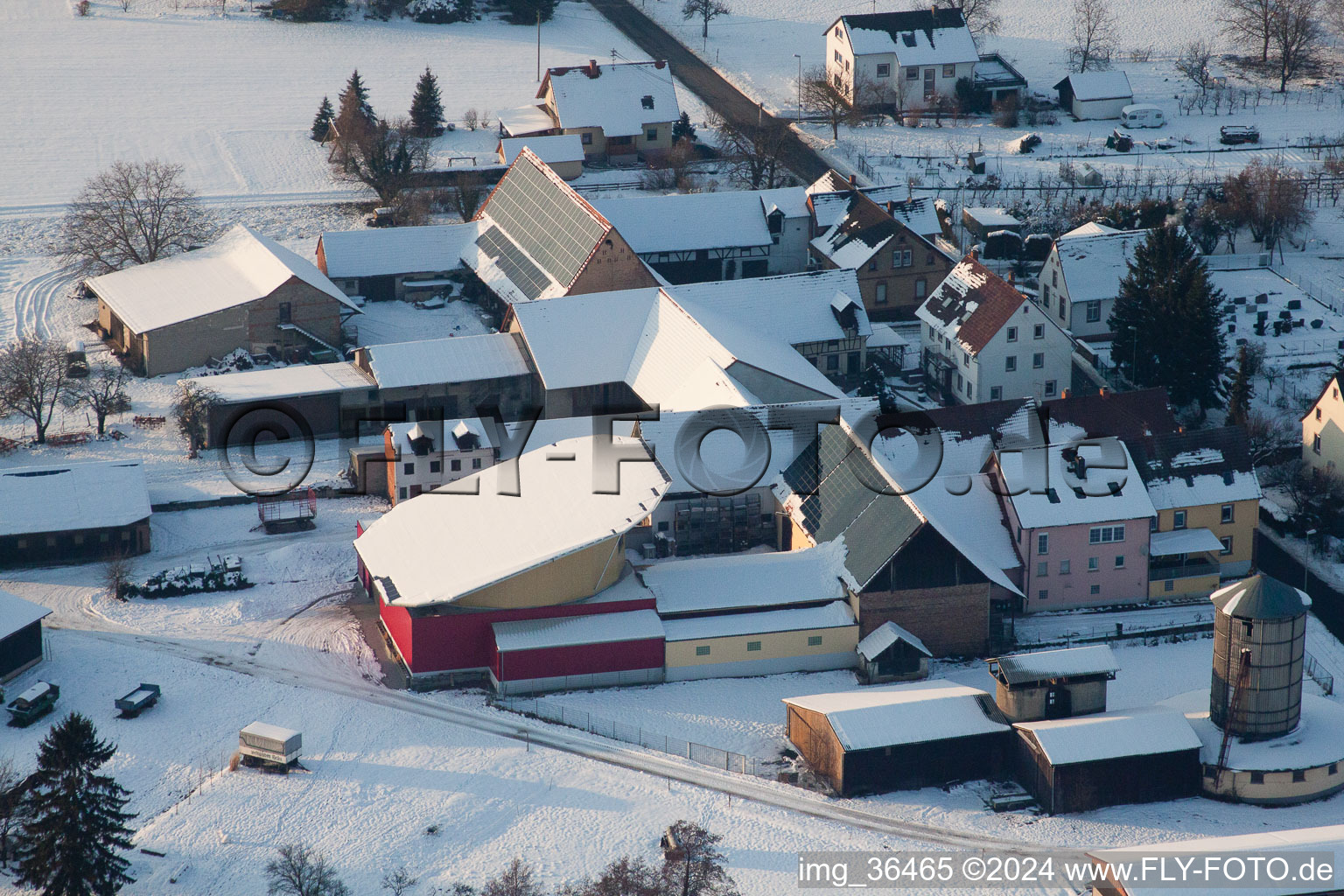 Aerial view of Wintry snowy Panel rows of photovoltaic turnable roof of a stable in the district Deutschhof in Kapellen-Drusweiler in the state Rhineland-Palatinate