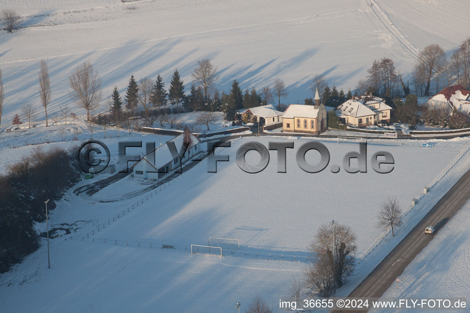 Football club with its own chapel in winter when there is snow in Neewiller-près-Lauterbourg in the state Bas-Rhin, France