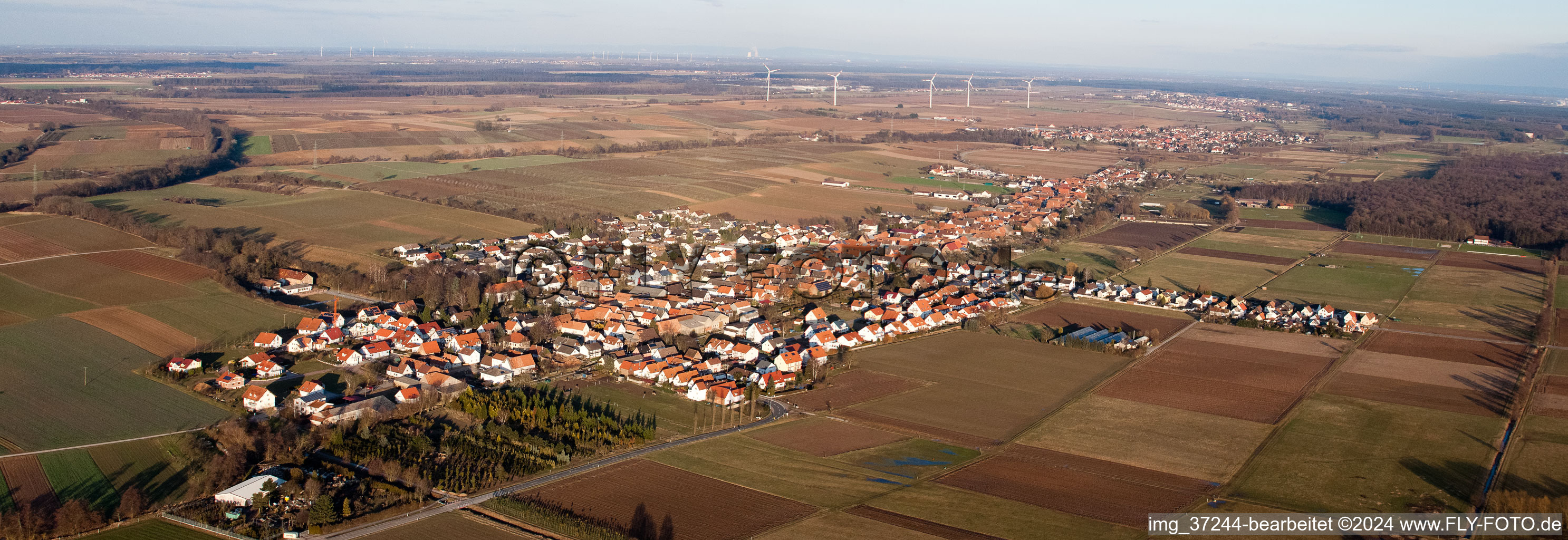 Panoramic perspective Village - view on the edge of agricultural fields and farmland in Freckenfeld in the state Rhineland-Palatinate, Germany