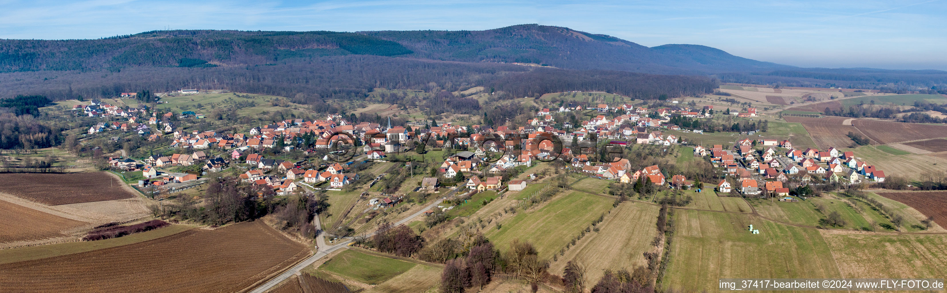 Panoramic perspective Village - view on the edge of agricultural fields and farmland in Lampertsloch in Grand Est, France