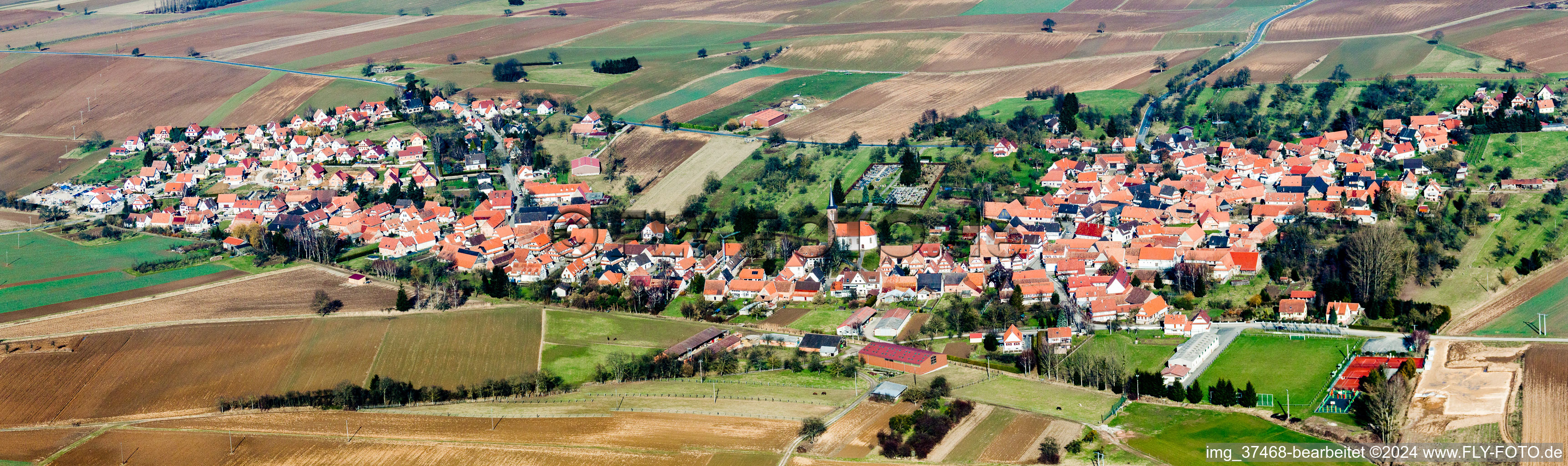 Village - view on the edge of agricultural fields and farmland in Hunspach in Grand Est, France