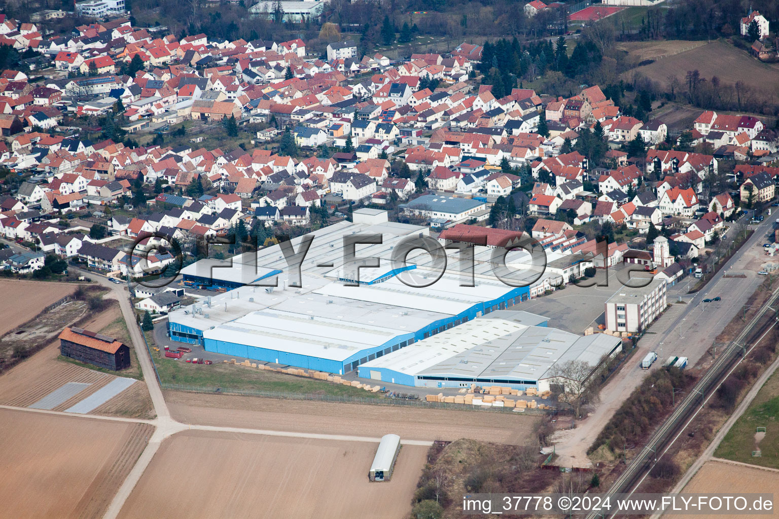 Aerial view of Warehouse complex-building in the industrial area TRANSAC Intern. Speditionsgesellschaft mbH in Ruelzheim in the state Rhineland-Palatinate