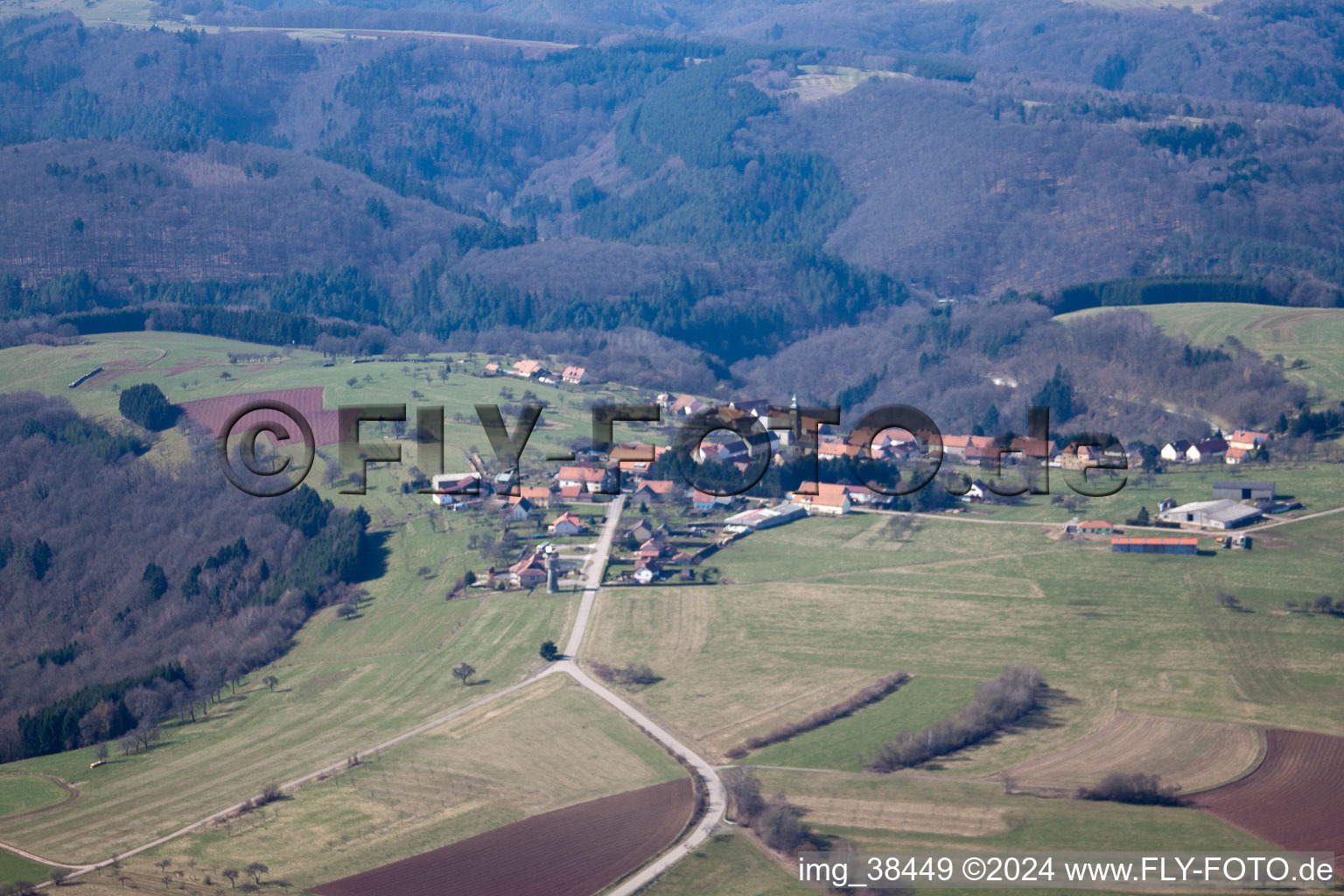 Village - view on the edge of agricultural fields and farmland in Liederschiedt in Grand Est, France