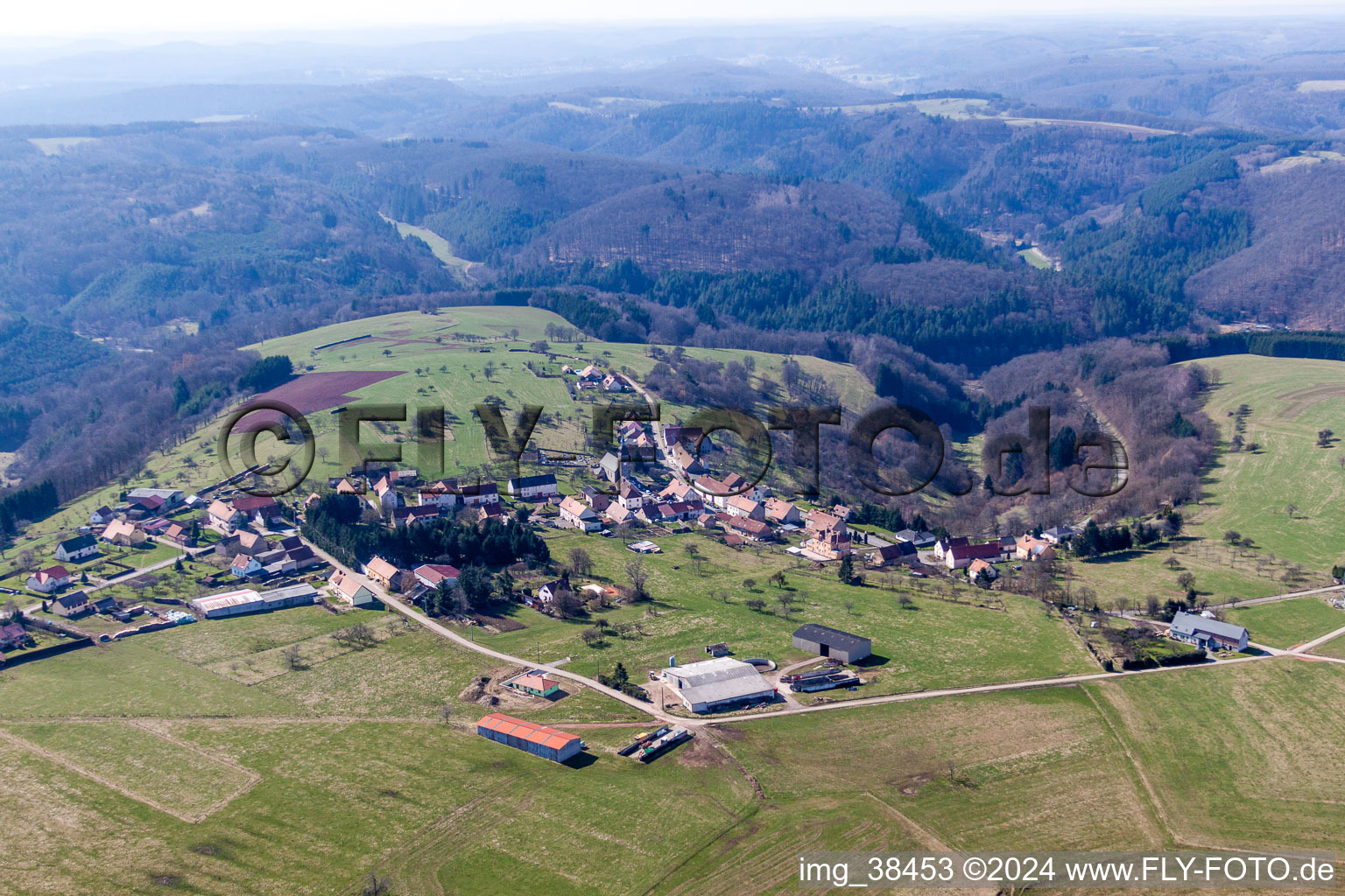 Aerial view of Village - view on the edge of agricultural fields and farmland in Liederschiedt in Grand Est, France