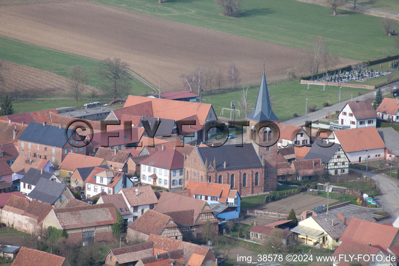 Aerial view of Village - view on the edge of agricultural fields and farmland in Geiswiller in Grand Est, France