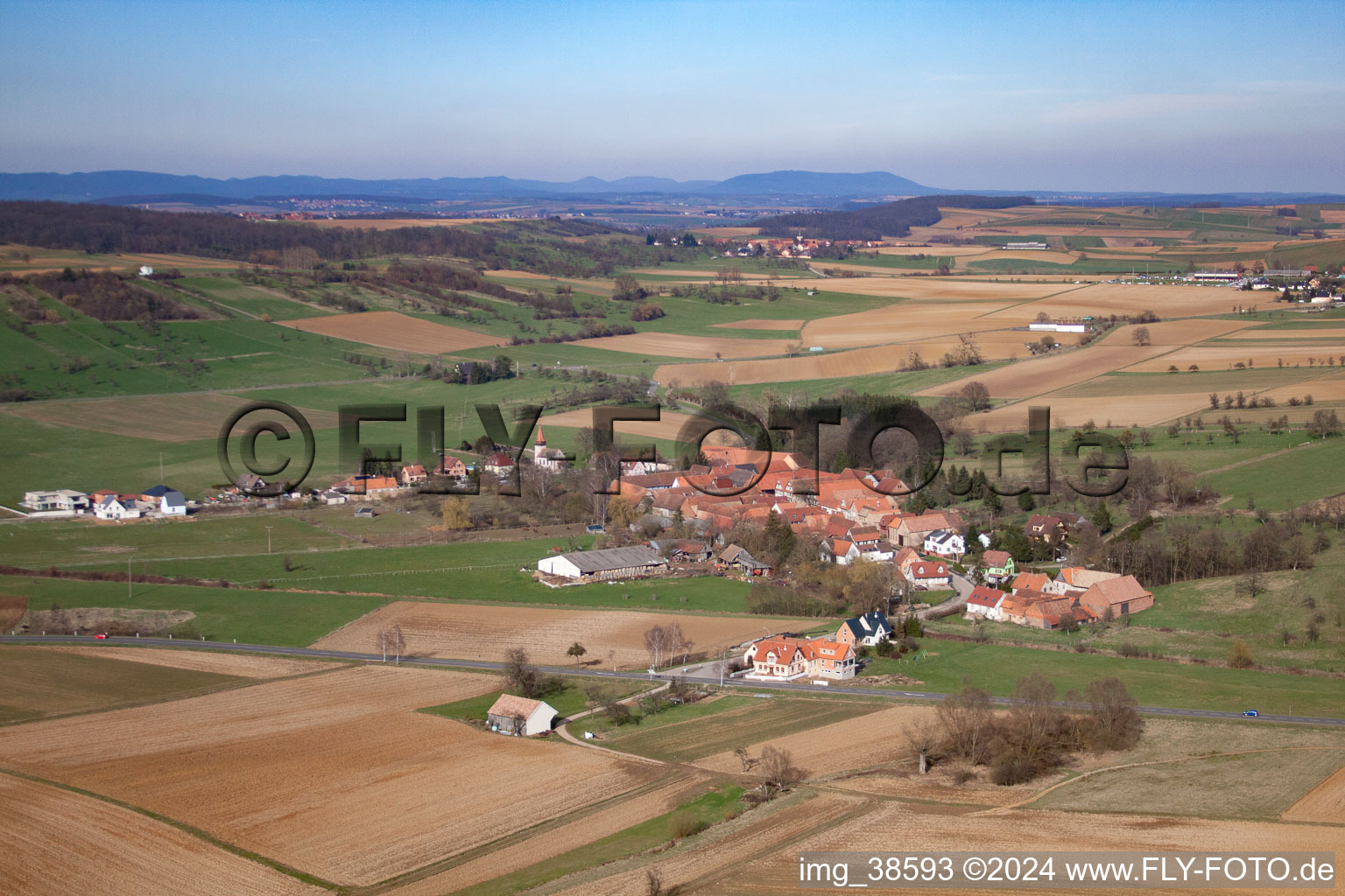 Village - view on the edge of agricultural fields and farmland in Issenhausen in Grand Est, France