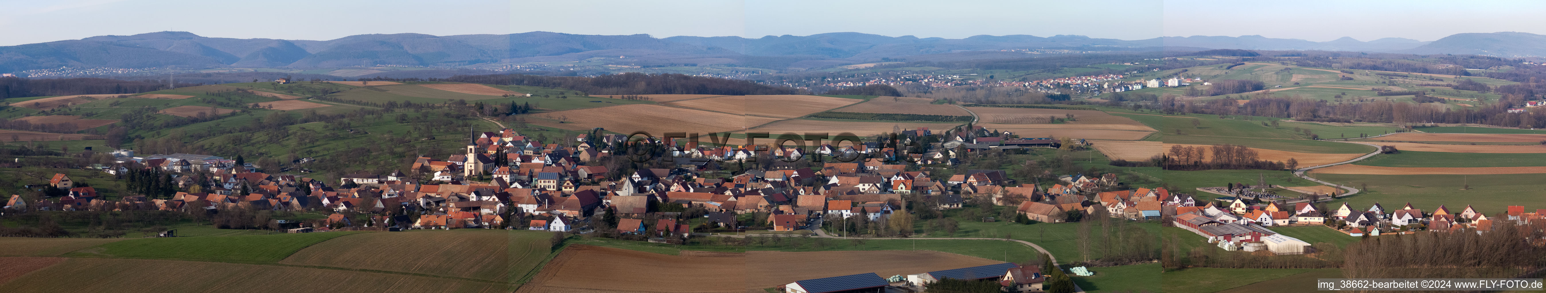 Panoramic perspective Village - view on the edge of agricultural fields and farmland in Mietesheim in Grand Est, France