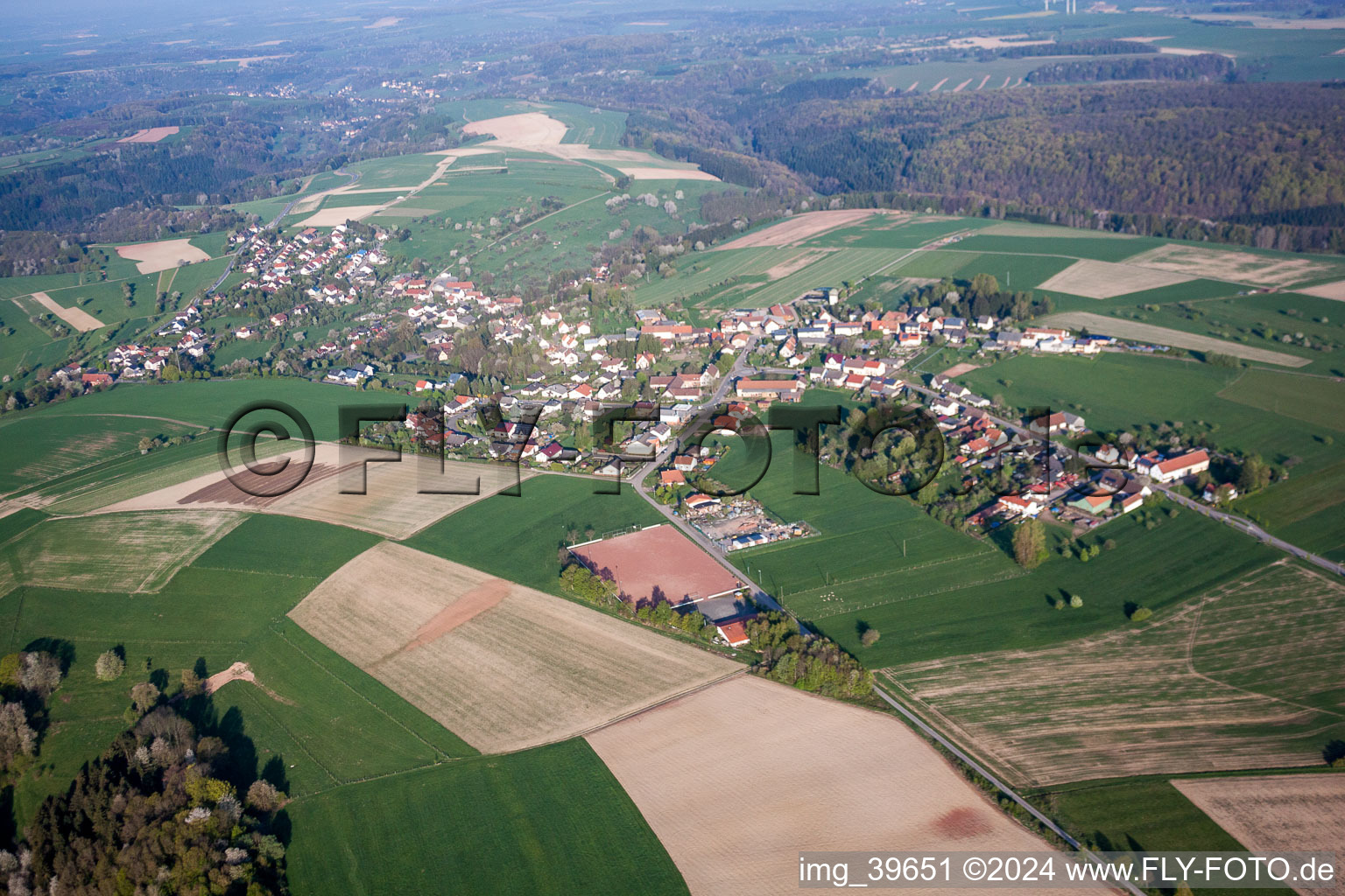 Village - view on the edge of agricultural fields and farmland in Kroeppen in the state Rhineland-Palatinate, Germany