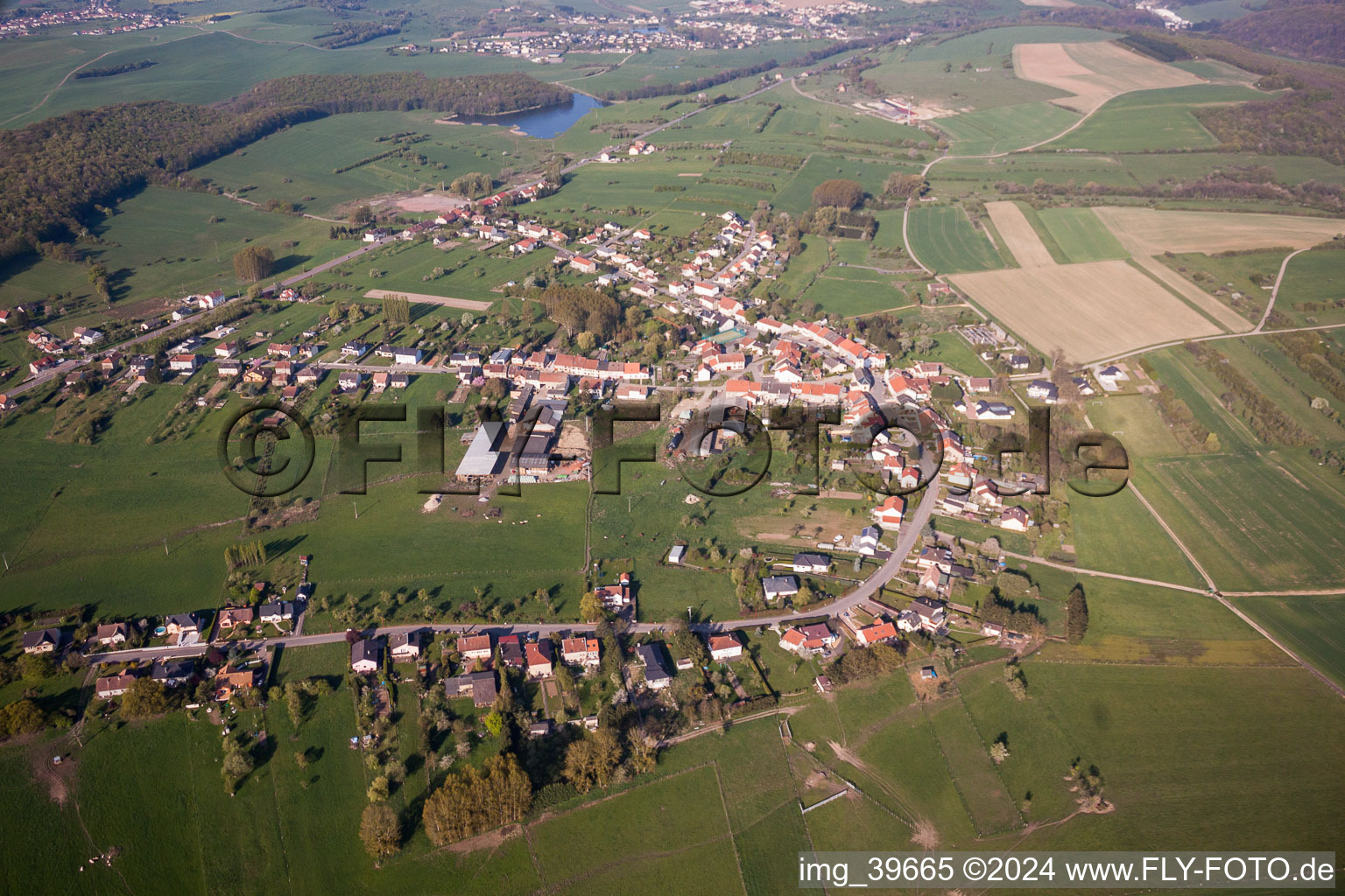 Village - view on the edge of agricultural fields and farmland in Macheren in Grand Est, France