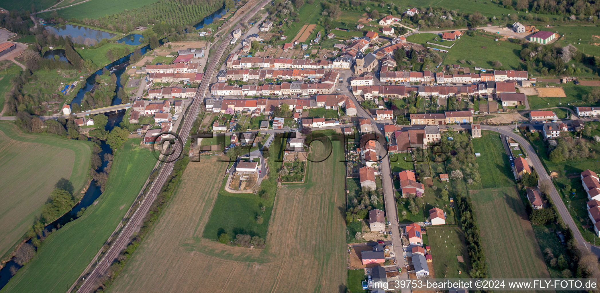 Aerial view of Village - view on the edge of agricultural fields and farmland in Charency-Vezin in Grand Est, France
