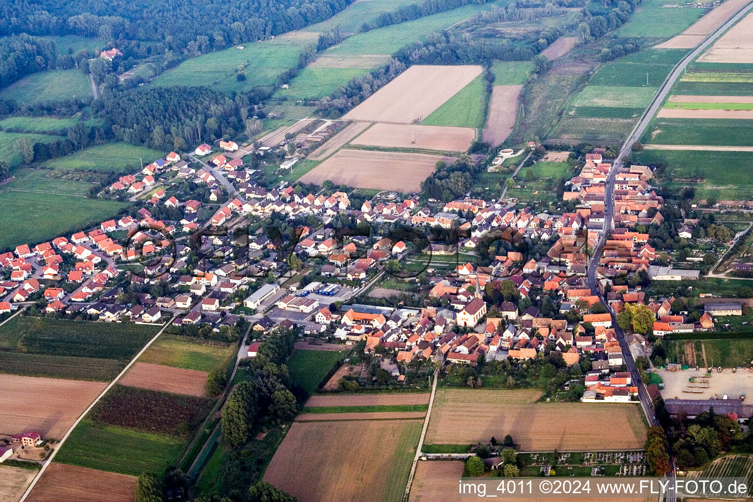 Aerial view of Village - view on the edge of agricultural fields and farmland in Knittelsheim in the state Rhineland-Palatinate