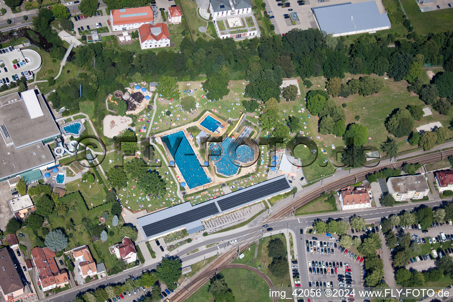 Bathers on the lawn by the pool of the swimming pool Albgau Freibad in Ettlingen in the state Baden-Wurttemberg