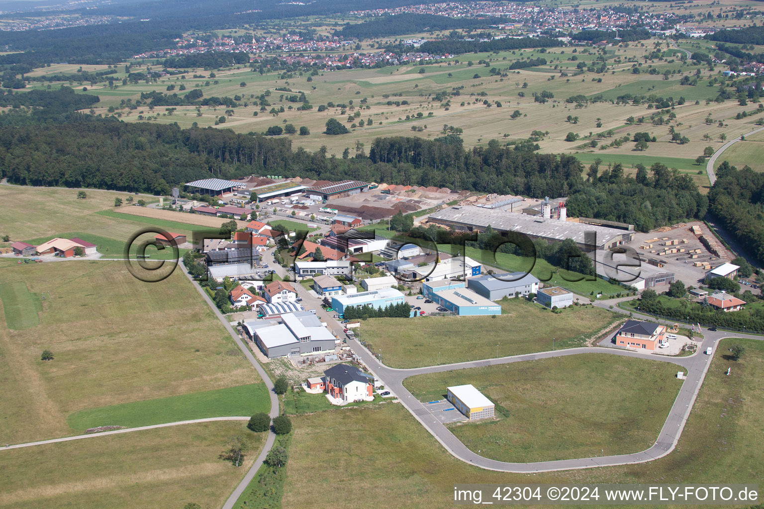 Building and production halls on the premises of corthum Nordschwarzwald GmbH - corthum Erdenwerk in the district Pfaffenrot in Marxzell in the state Baden-Wurttemberg from the plane