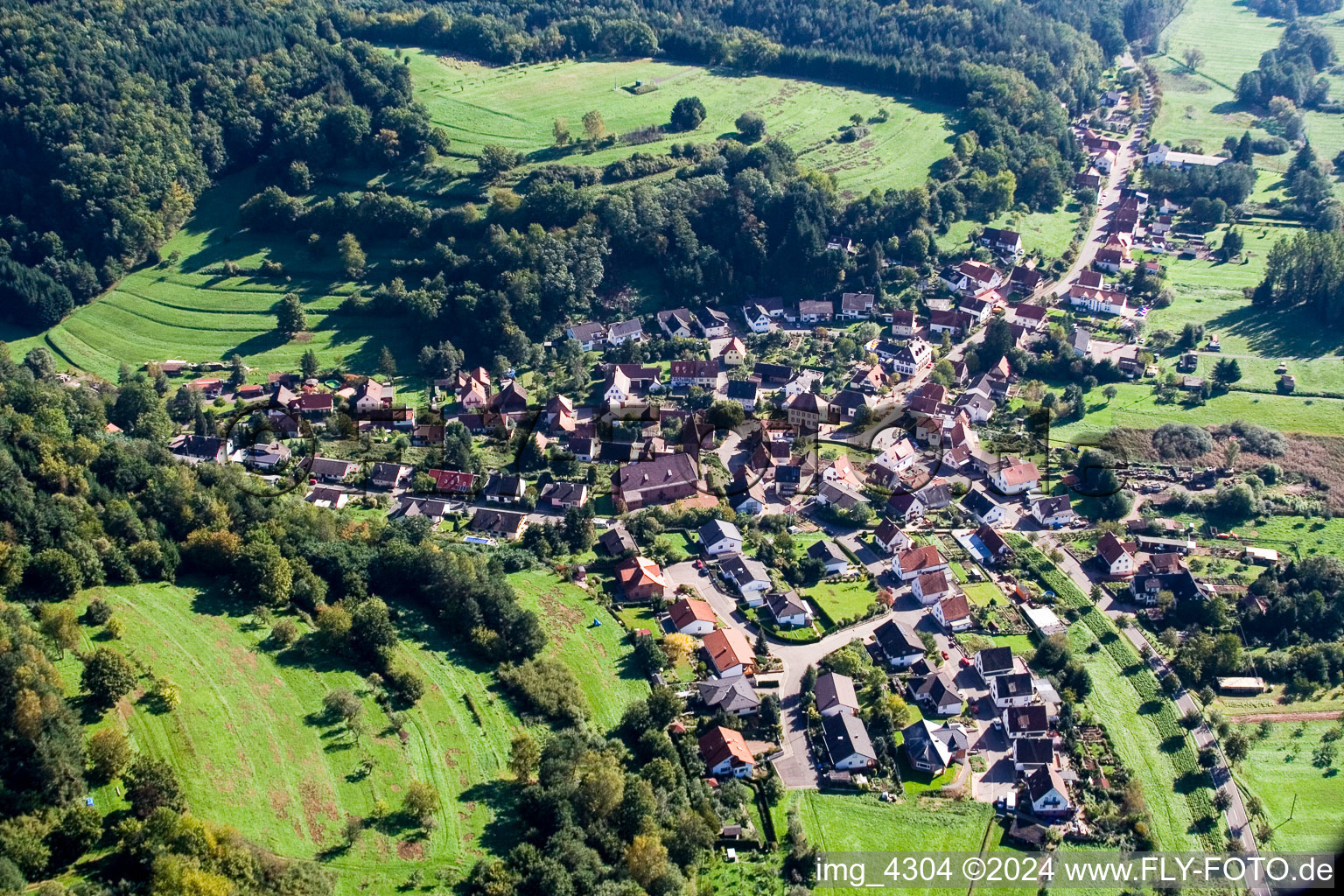 Aerial photograpy of Village - view on the edge of agricultural fields and farmland in Niederschlettenbach in the state Rhineland-Palatinate