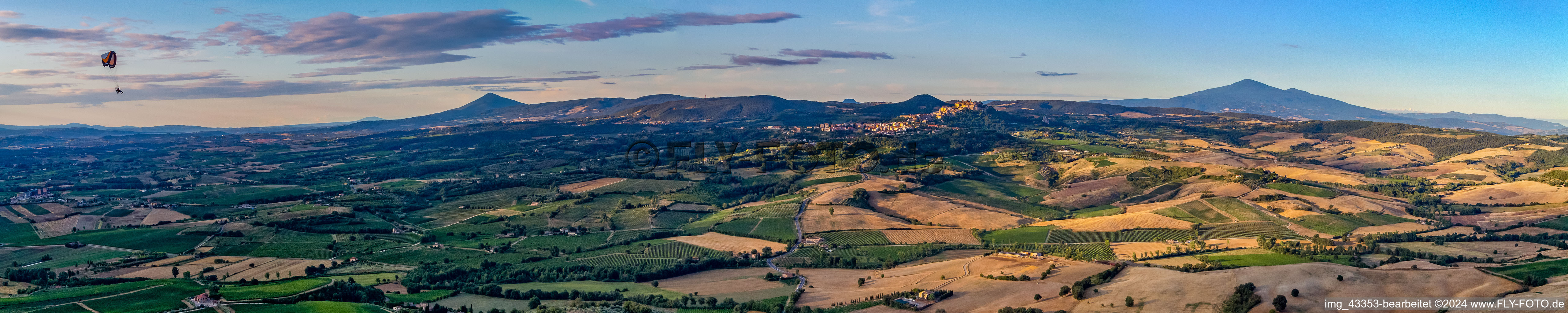 Panoramic perspective of Rocky and mountainous landscape with Paraglider in Montepulciano in Toskana, Italy