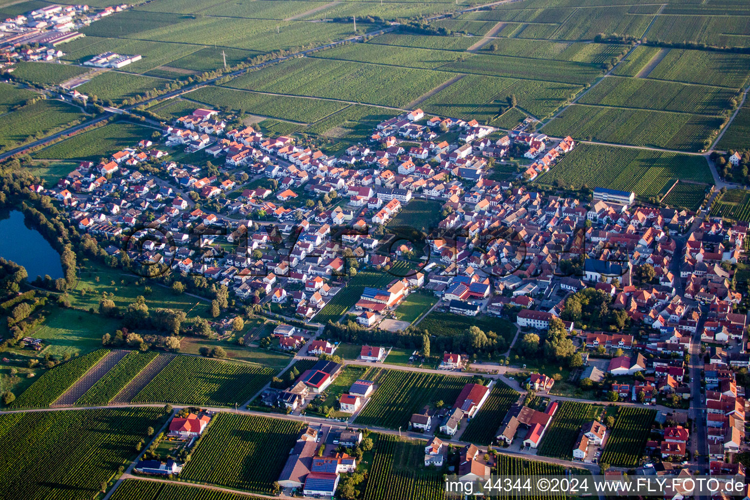 Village - view on the edge of agricultural fields and farmland in Kirrweiler (Pfalz) in the state Rhineland-Palatinate, Germany seen from above