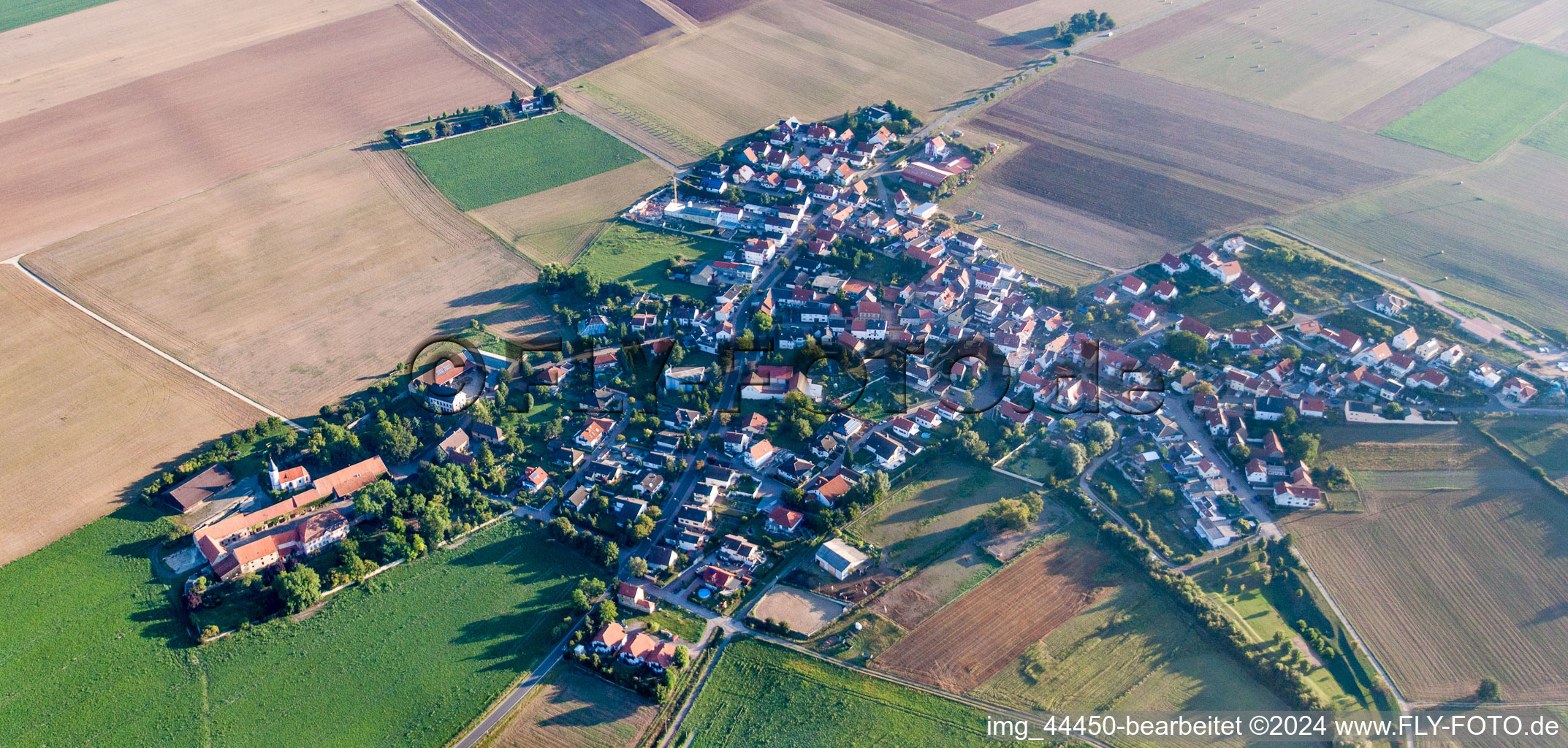 Village - view on the edge of agricultural fields and farmland in Quirnheim in the state Rhineland-Palatinate, Germany
