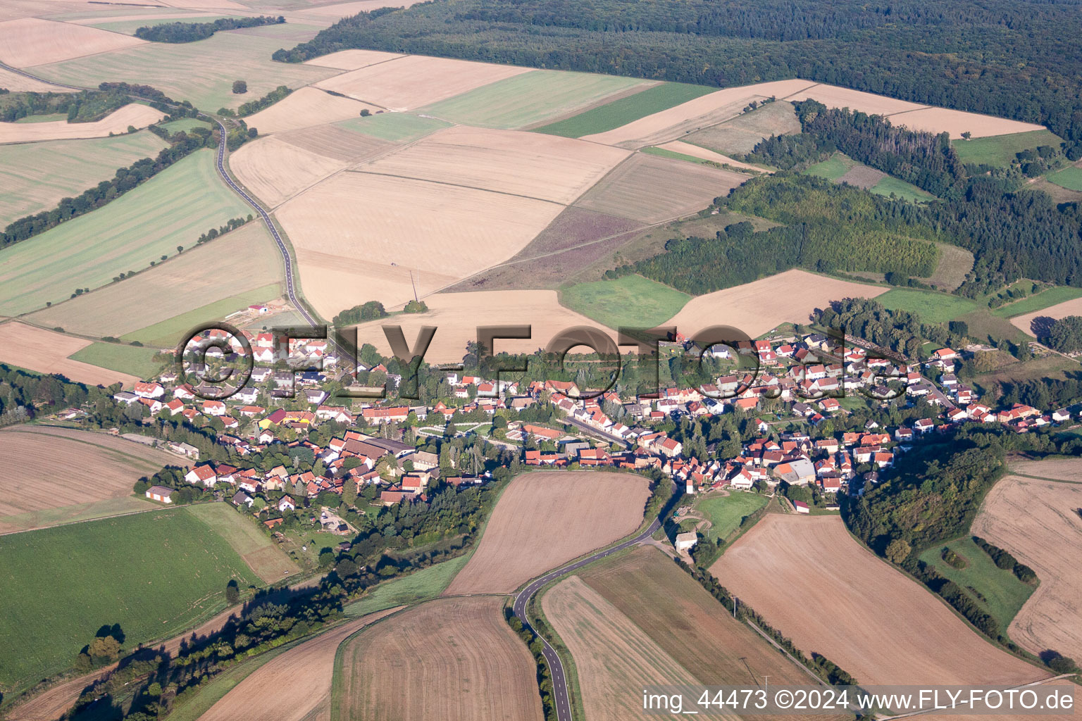 Village - view on the edge of agricultural fields and farmland in Nieder-Wiesen in the state Rhineland-Palatinate, Germany