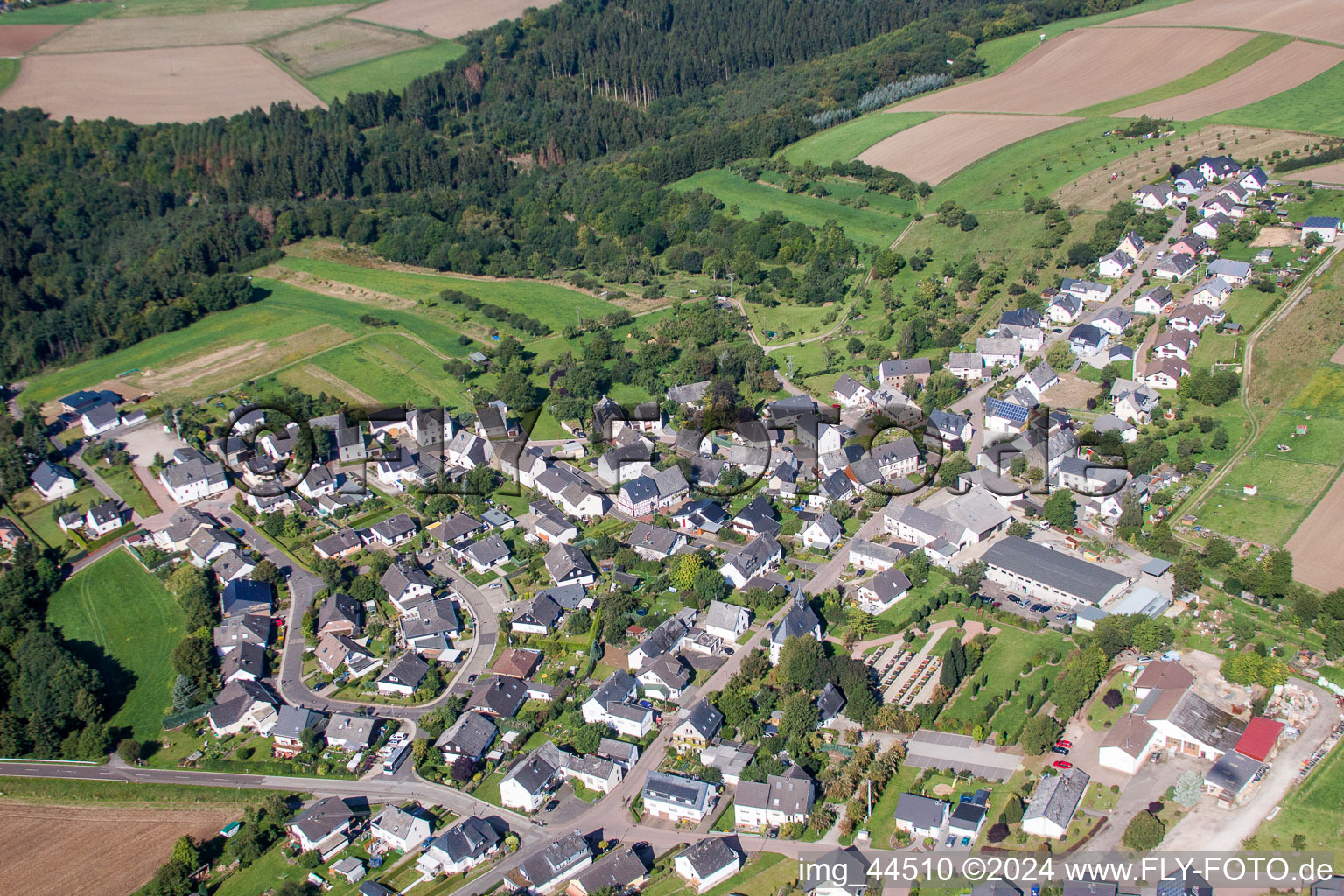 Village - view on the edge of agricultural fields and farmland in Kratzenburg in the state Rhineland-Palatinate, Germany