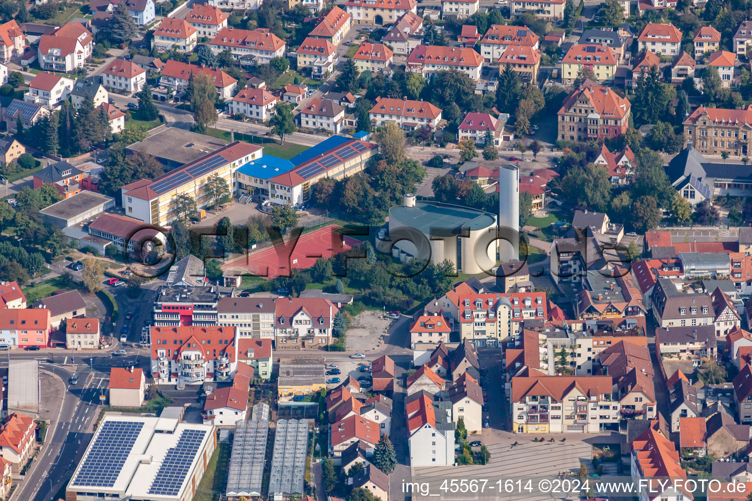 School building of the Theodor-Heuss-School and of a church in Sinsheim in the state Baden-Wurttemberg, Germany