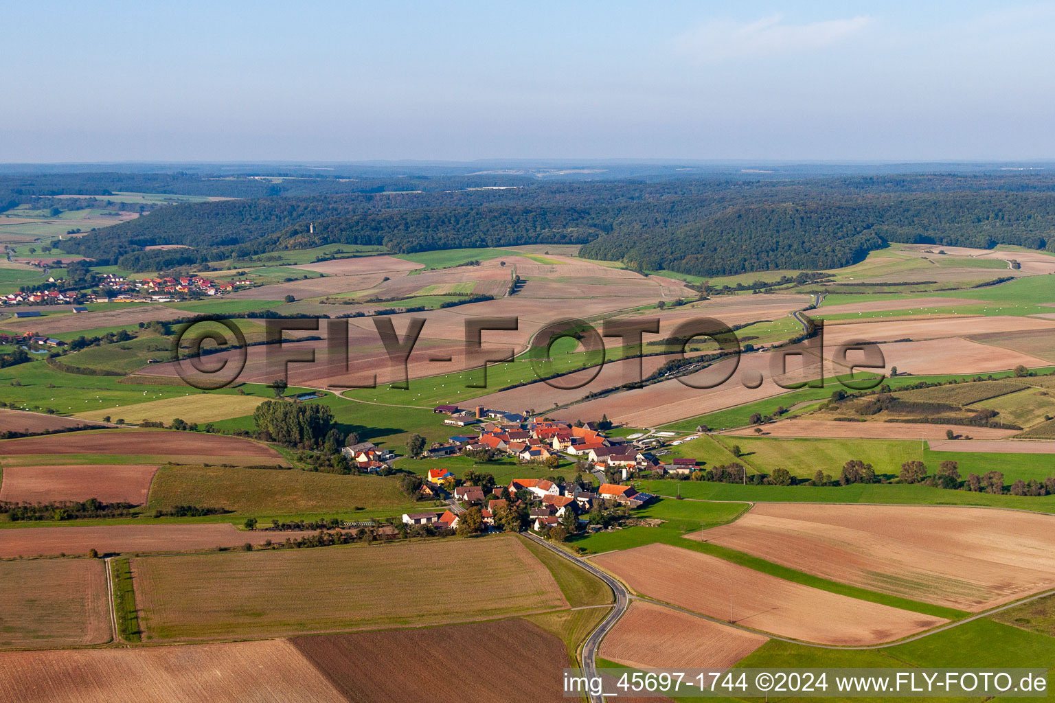 Aerial view of Village - view on the edge of agricultural fields and farmland in the district Schnodsenbach in Scheinfeld in the state Bavaria, Germany