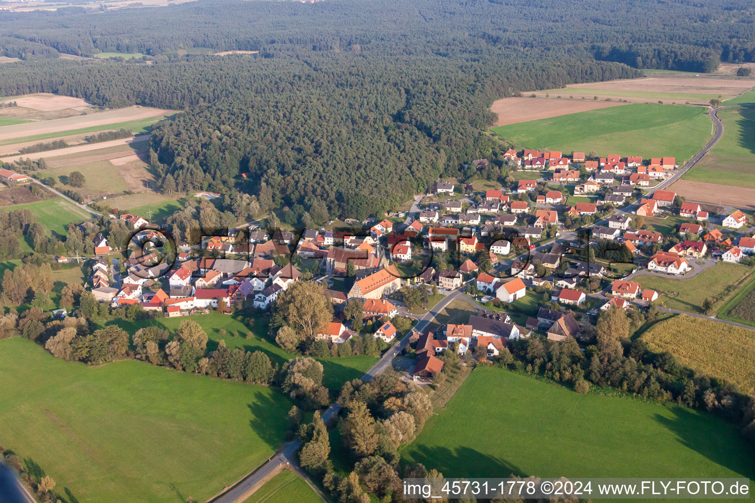 Village - view on the edge of agricultural fields and farmland in Schluesselau in the state Bavaria, Germany