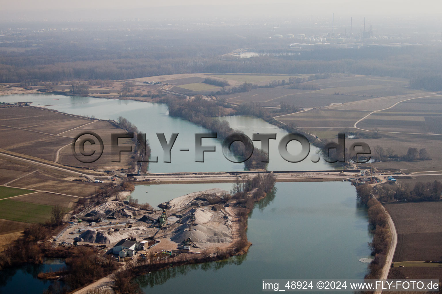 Polder dam through the quarry lake in Neupotz in the state Rhineland-Palatinate, Germany