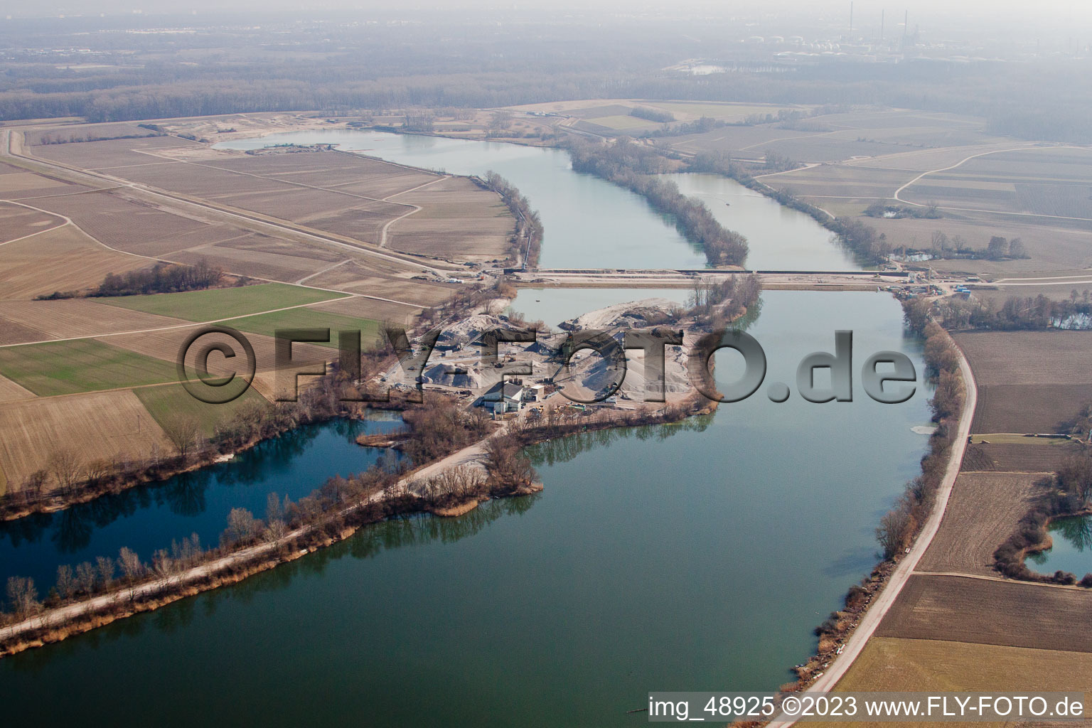 Aerial view of Polder dam through the quarry lake in Neupotz in the state Rhineland-Palatinate, Germany